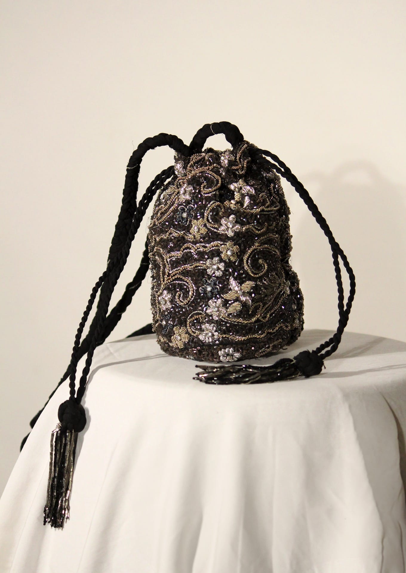 Intricate lace-like silver beadwork on a twilight purse, authentic Lucknow artisan fashion.