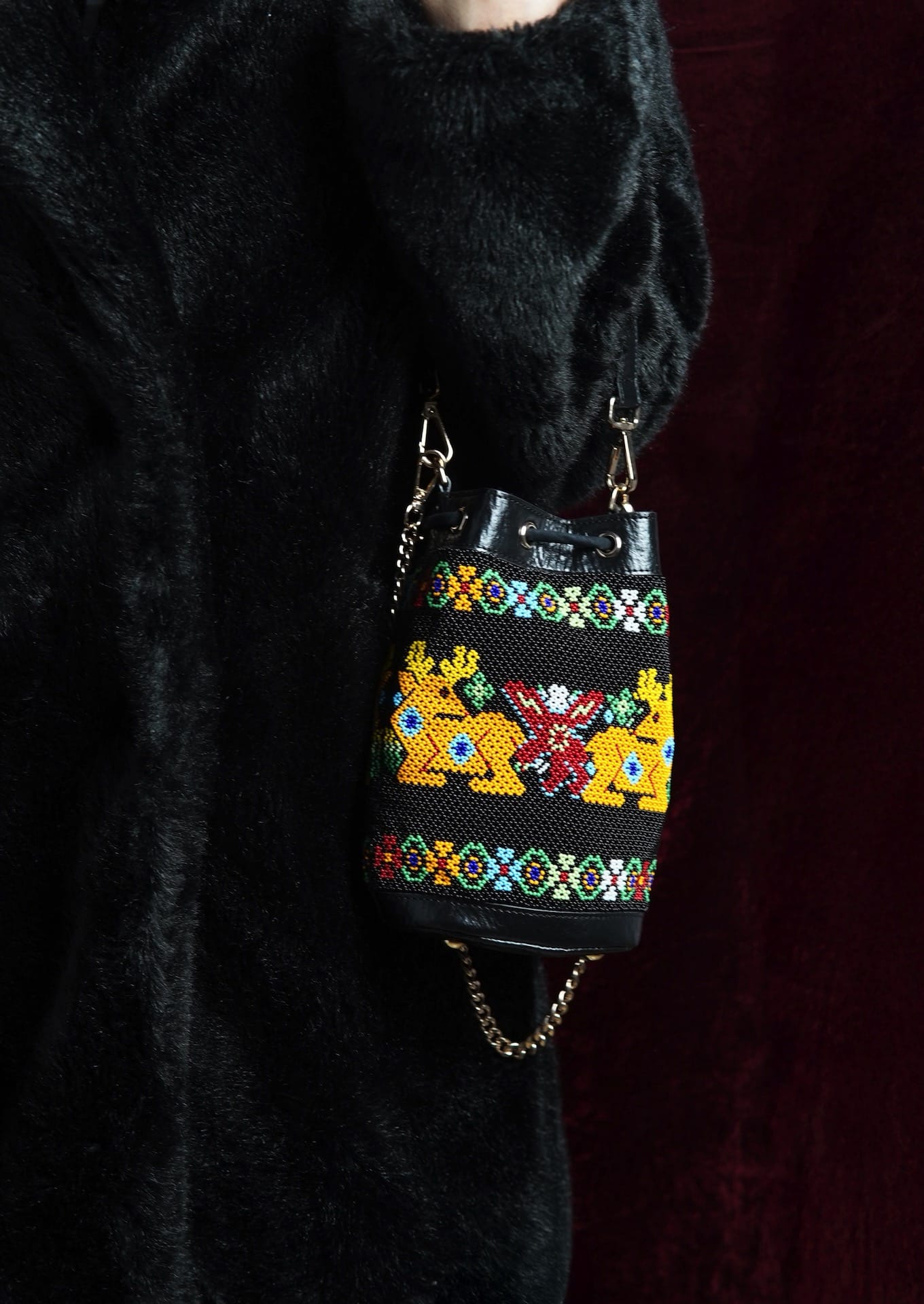 Handcrafted eco-friendly beaded potli styled with a black outfit, authentic Indian artisanal bag.