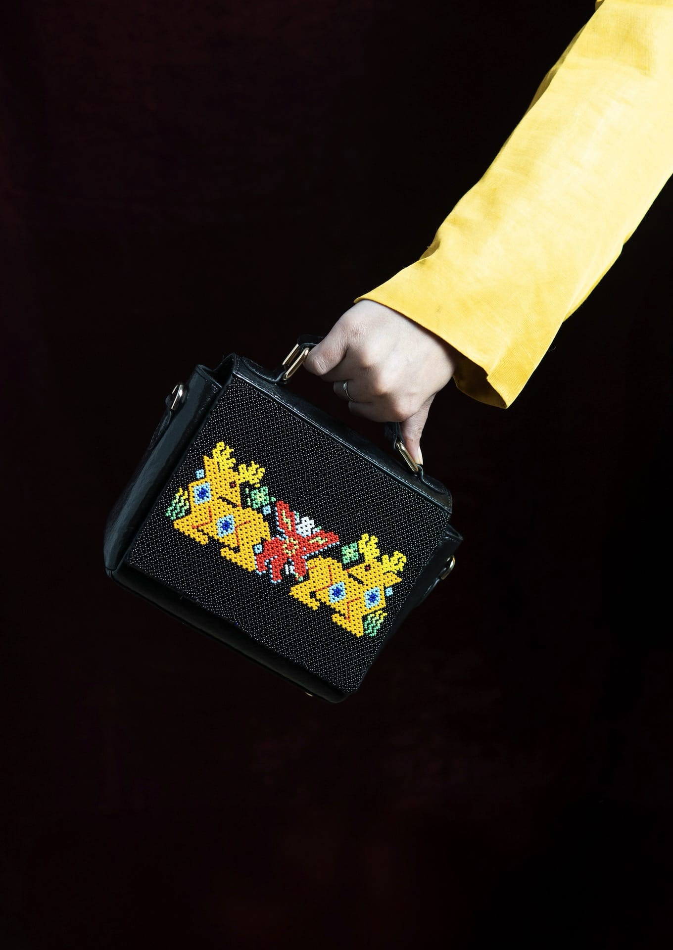 Traditional dal-moti beadwork wildlife motifs on a structured bag, Saurashtra artisan craft.