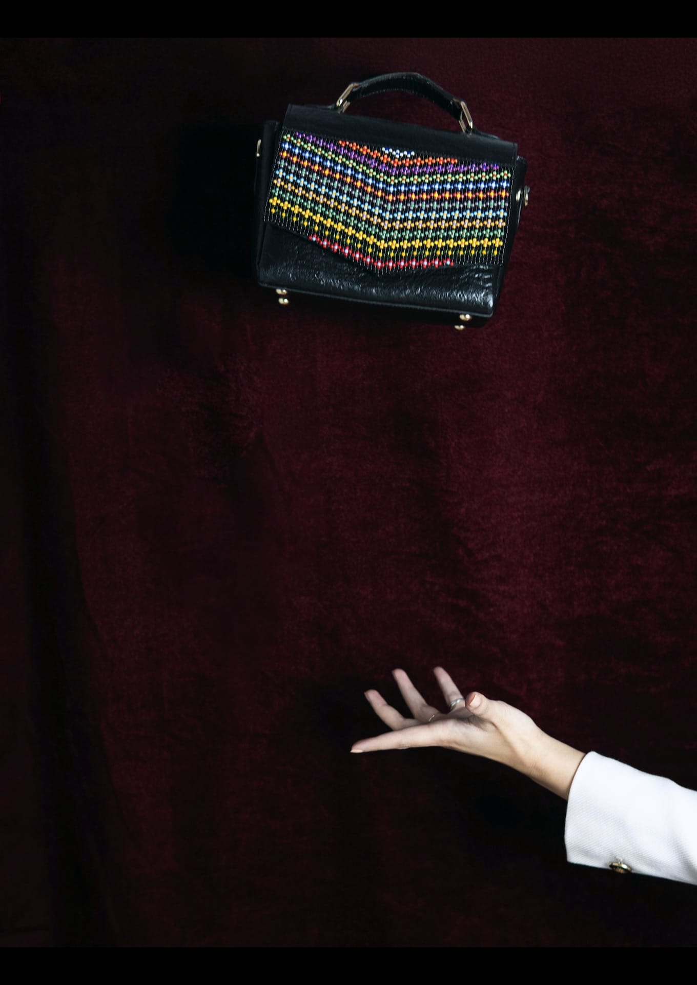 Traditional Gujarati Toran patterns on a modern handbag, authentic Saurashtra artisanal fashion.