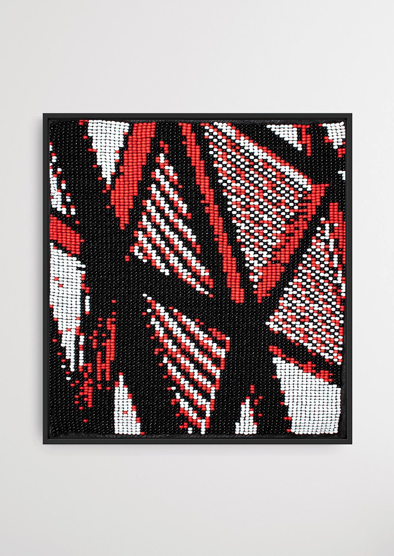 Handwoven abstract art piece with red, black, and white patterns from Gujarat.