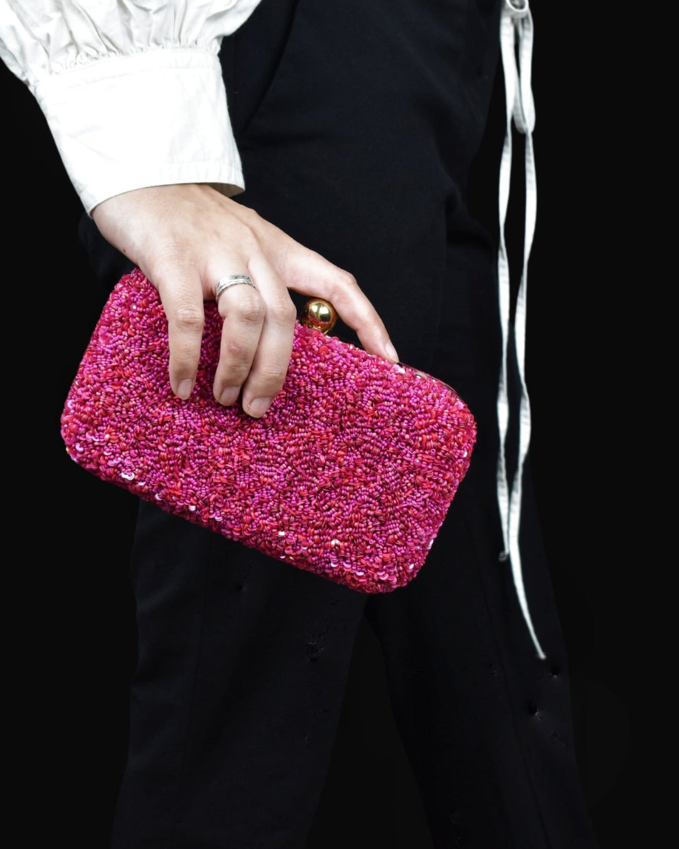 Another angle of shimmering hand-sewn pink beadwork on an elegant clutch, authentic Uttar Pradesh fashion.