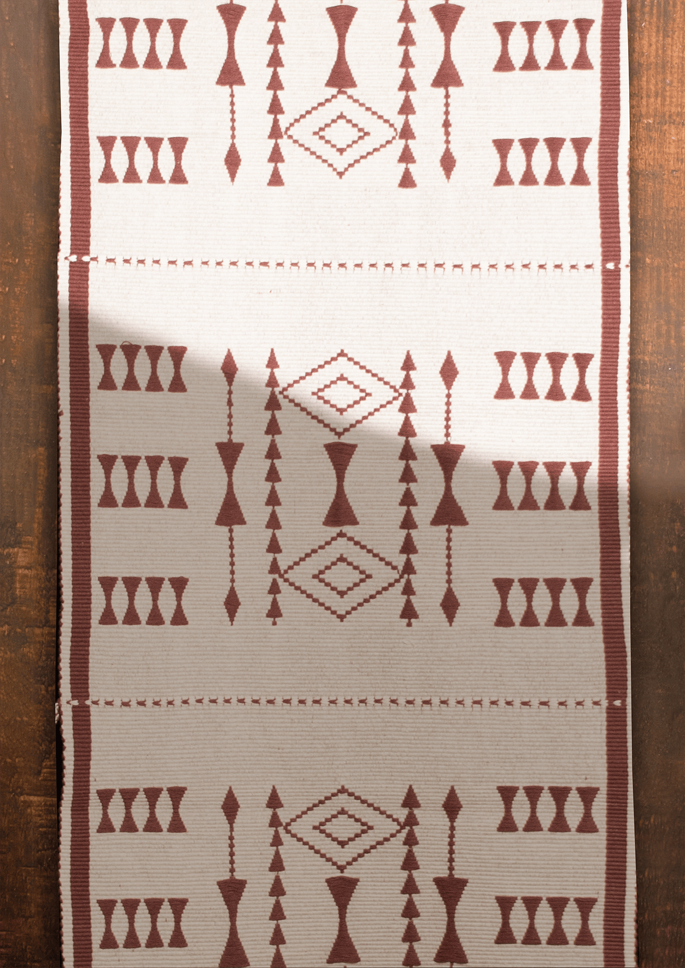 Handwoven cream cotton Tekru table runner with red tribal motifs, authentic Naga loin loom textile.