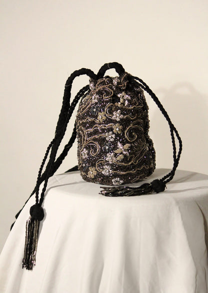 Intricate lace-like silver beadwork on a twilight purse, authentic Lucknow artisan fashion.