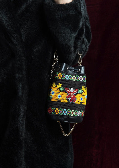 Handcrafted eco-friendly beaded potli styled with a black outfit, authentic Indian artisanal bag.