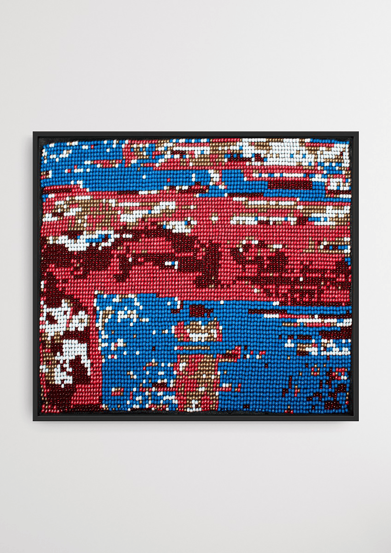 Framed red and blue geometric glass bead artwork, traditional Gujarati bead-loom wall decoration.