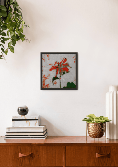 Hand-stitched orange flower glass bead design on a white wall, authentic Indian heirloom room art.