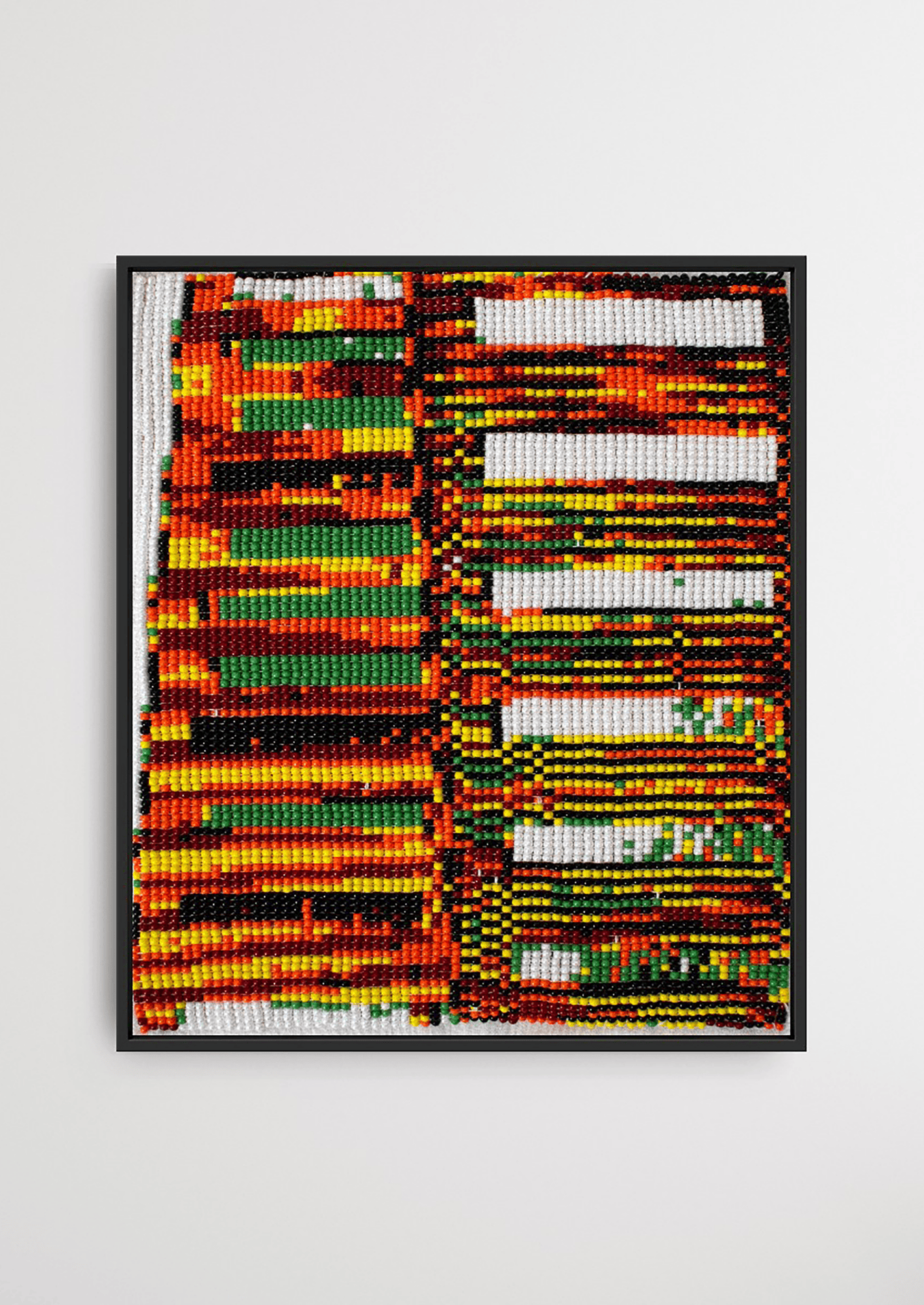 Framed intersecting green and red linear glass bead artwork, traditional Gujarati handicraft wall decor.