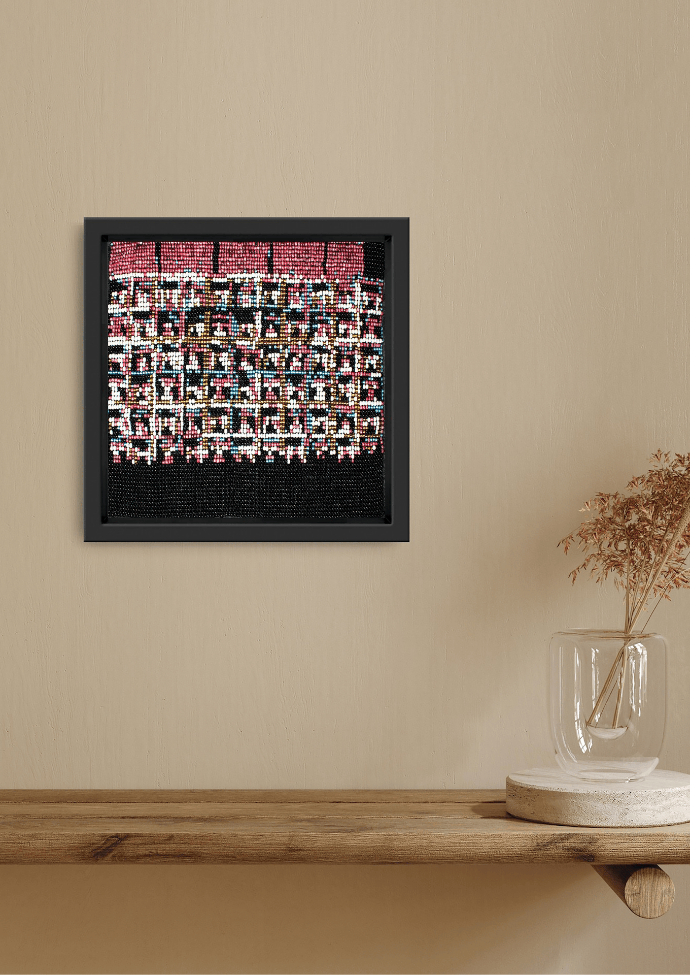 Framed pink and red abstract rows of glass bead artwork, handwoven Gujarati beadwork decor.