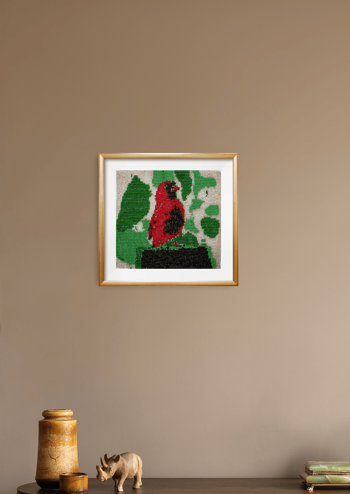 Young bird glass bead-loom piece styled on a minimalist wall, authentic Indian handicraft room art.