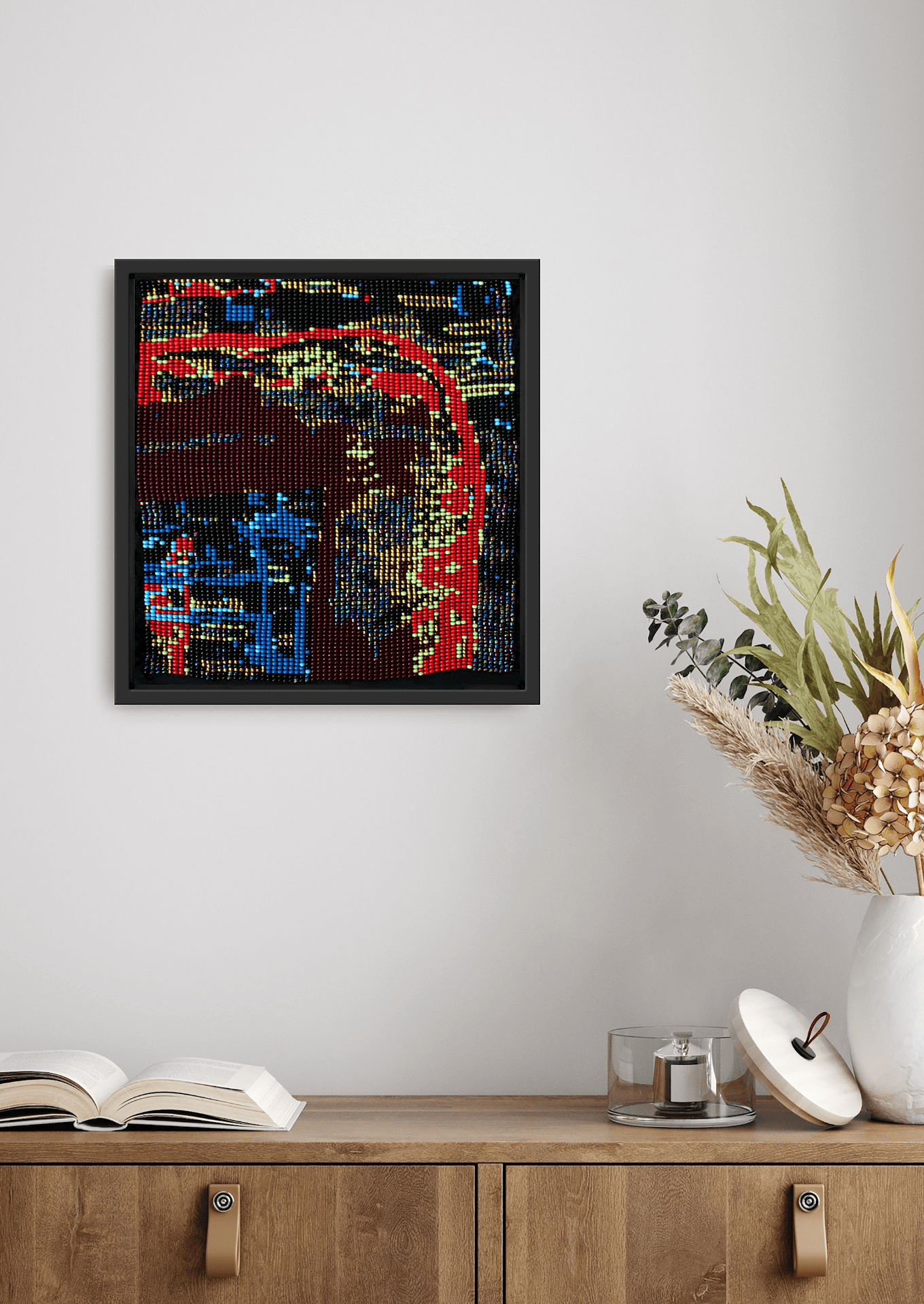 Framed dark abstract layered texture glass bead artwork, handcrafted Gujarati heirloom wall art above wooden cabinet.