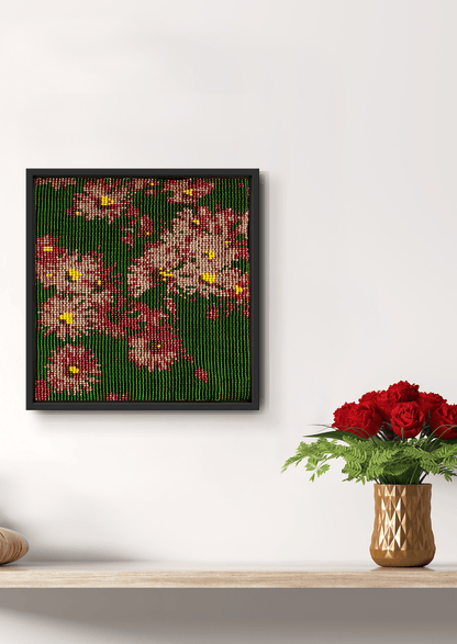 Hand-stitched pink and green floral beadwork piece on a white wall, premium Indian handicraft.