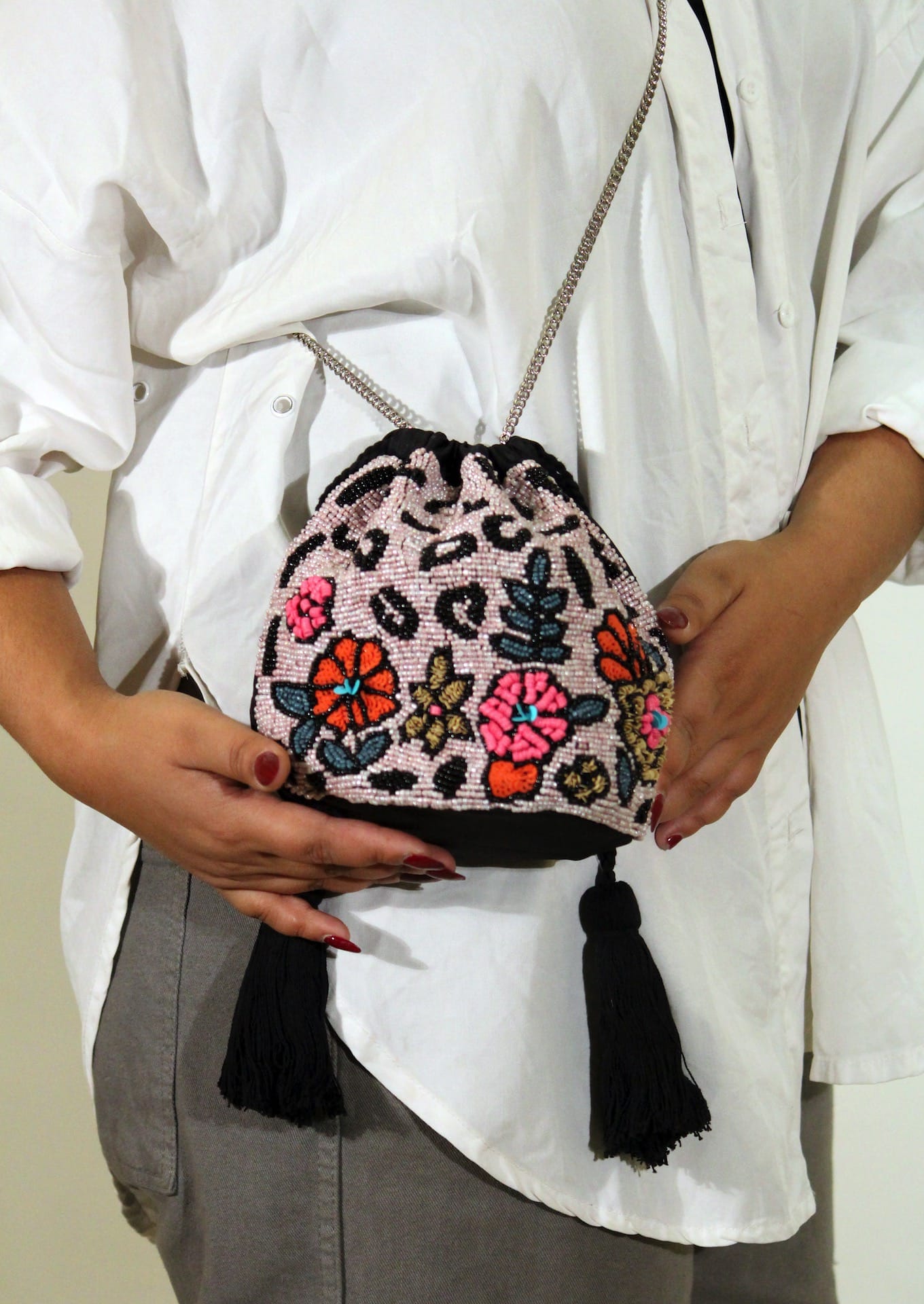  Detailed view of sequenced floral motifs on midnight canvas, luxury handcrafted evening bag.