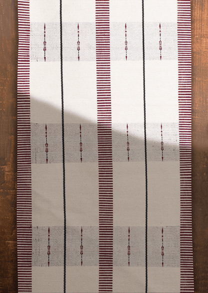 Handwoven cream cotton Angami table runner with maroon stripes, authentic Naga handicraft.