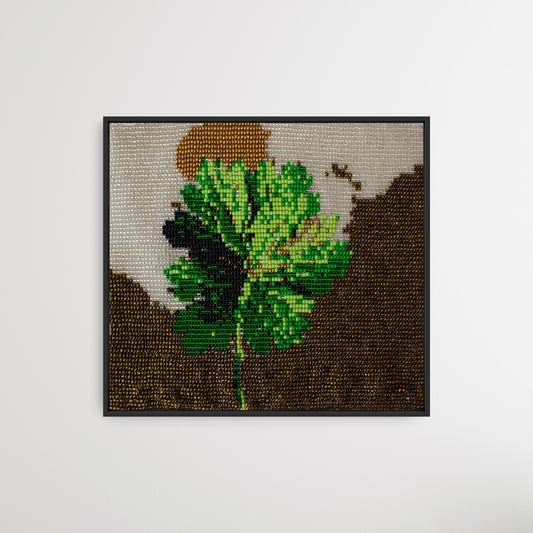 Framed green four-leaf clover glass bead artwork, handwoven Gujarati bead-loom wall decor.
