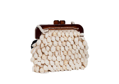 Diagonal view of ivory mother-of-pearl shell beaded day bag, handcrafted premium Indian luxury accessory.