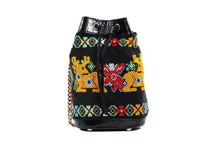 Vegan banana fiber bucket bag with Gujarati Dal Moti beadwork, sustainable Indian luxury accessory.