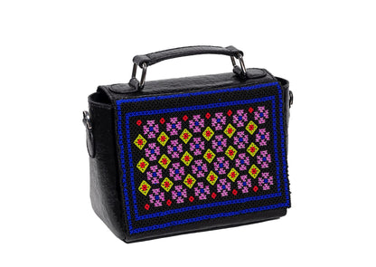 Diagonal view of black structured purse with colorful diamond motif beadwork, handcrafted premium Indian accessory.