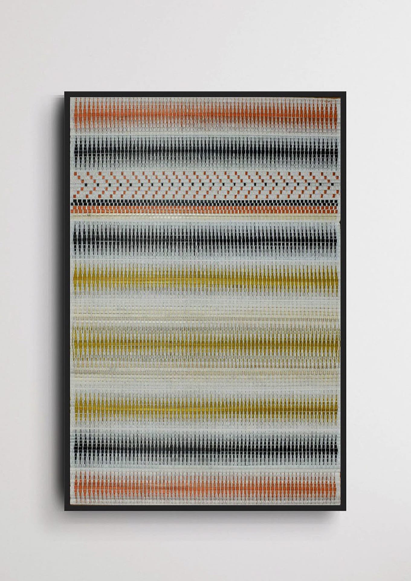 Woven bamboo scroll wall art with yellow and black accents, traditional Nagaland home decor.
