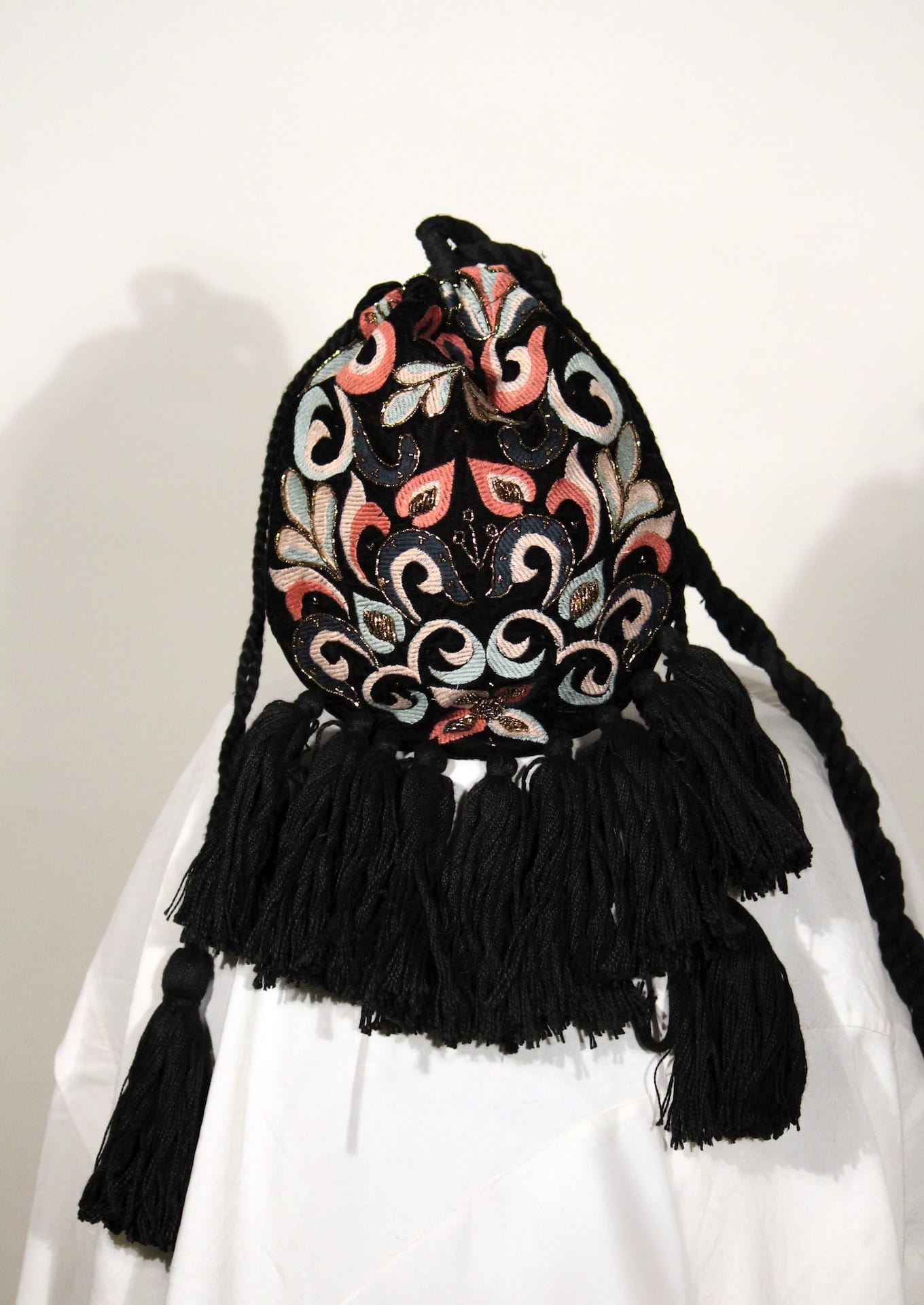 Black velvet potli bag with traditional floral beadwork, premium Indian handcrafted accessory.