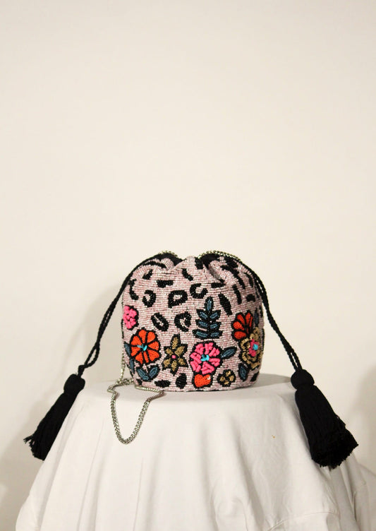 Black clutch bag with hand-beaded floral tapestry, premium Indian artisanal accessory.