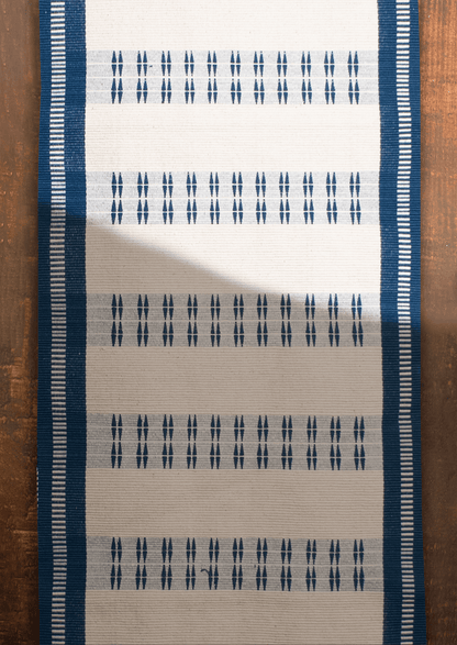Handwoven cotton Chakesang table runner with geometric navy blue patterns, traditional Naga textile.