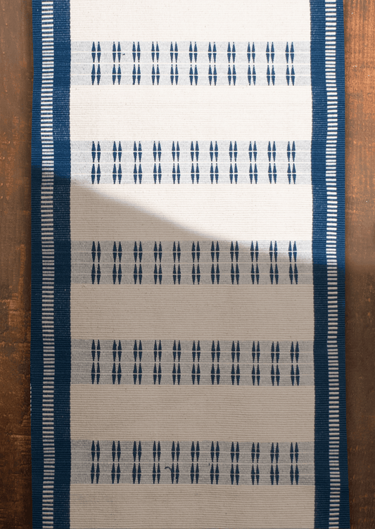 Handwoven cotton Chakesang table runner with geometric navy blue patterns, traditional Naga textile.