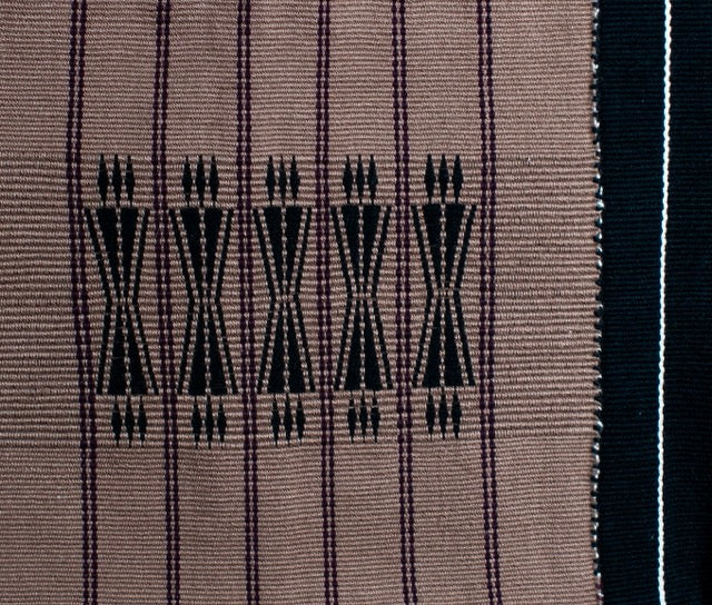 Detailed texture of brown and black cotton weaving, luxury Indian artisanal home decor.
