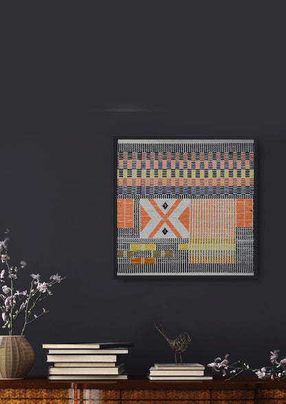 Intricate woven picture patterns on cotton yarn above wooden cabinet with plants, ornaments and books, luxury Indian handicraft art.