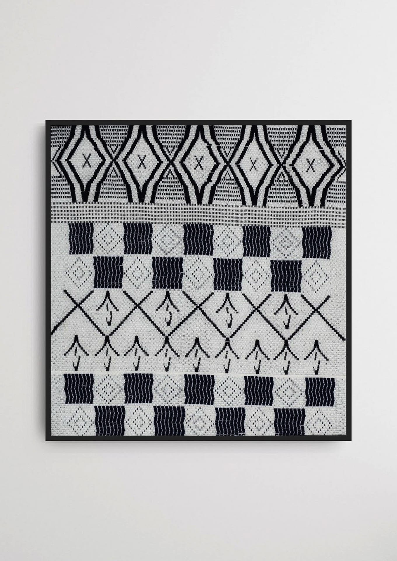 Intricate geometric weaving on a framed cotton textile, premium Indian heritage wall decor.