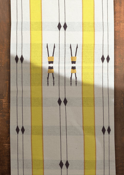 Handwoven cotton Mechu table runner with yellow stripes and tribal motifs, premium Naga textile art.