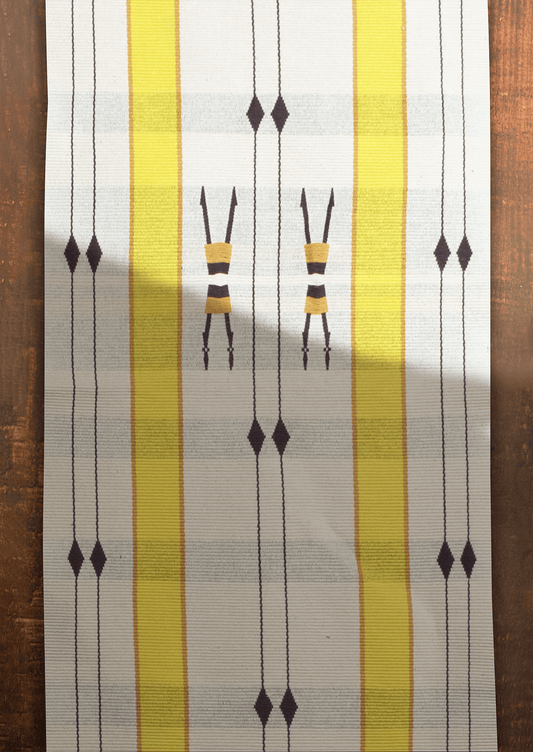Handwoven cotton Mechu table runner with yellow stripes and tribal motifs, premium Naga textile art.