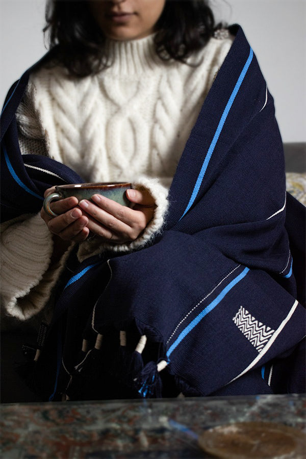 Cozy dark blue cotton throw draped elegantly, premium Indian handcrafted home accessory.