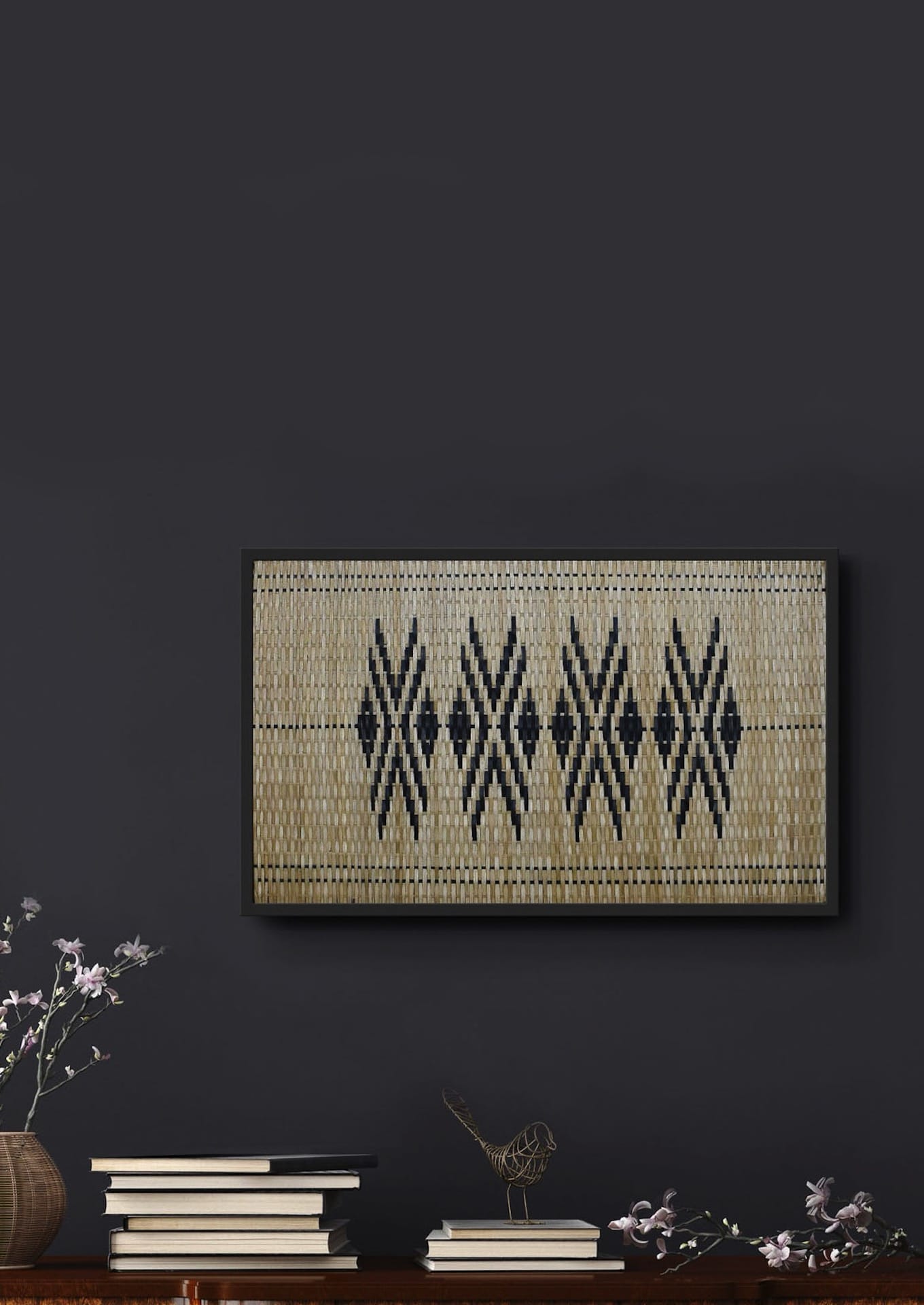 Bamboo textile artwork inspired by tribal tattoos displayed with plants and books, premium Indian decor.