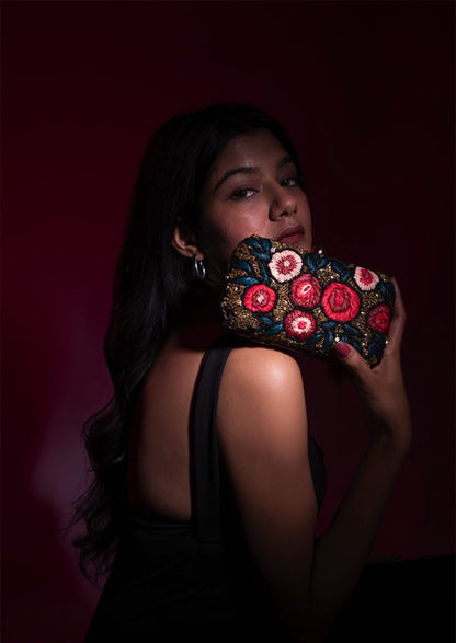 Hand-beaded midnight canvas clutch with red rose motifs, authentic Agra artisan fashion.