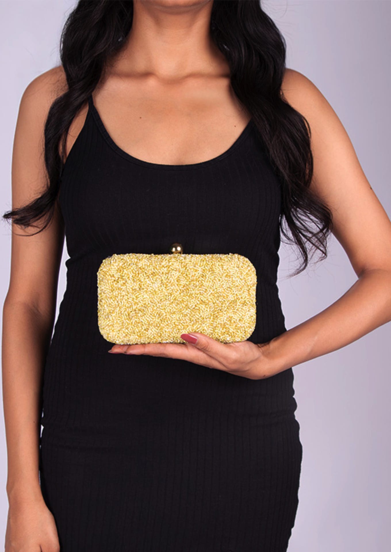 Brilliant yellow beaded day clutch, handcrafted premium Indian luxury accessory displayed by a person.