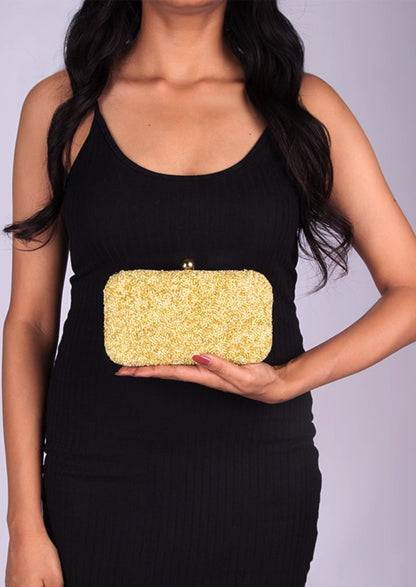 Brilliant yellow beaded day clutch, handcrafted premium Indian luxury accessory displayed by a person.